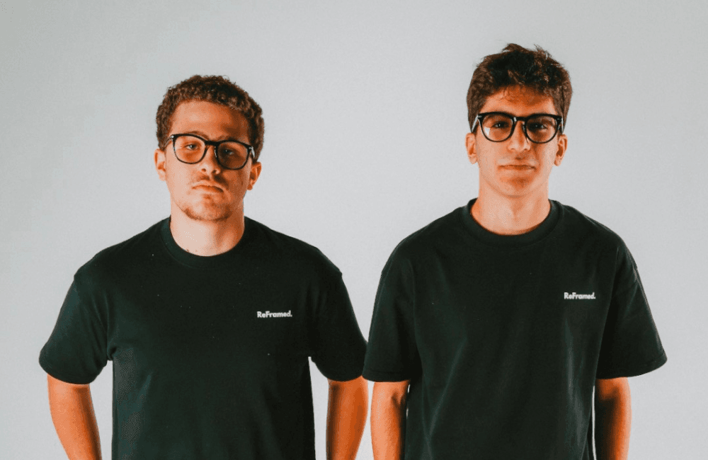 ReFramed founders Jason Azzi and Jad Chabtini in black ReFramed t-shirts against a plain gray background.