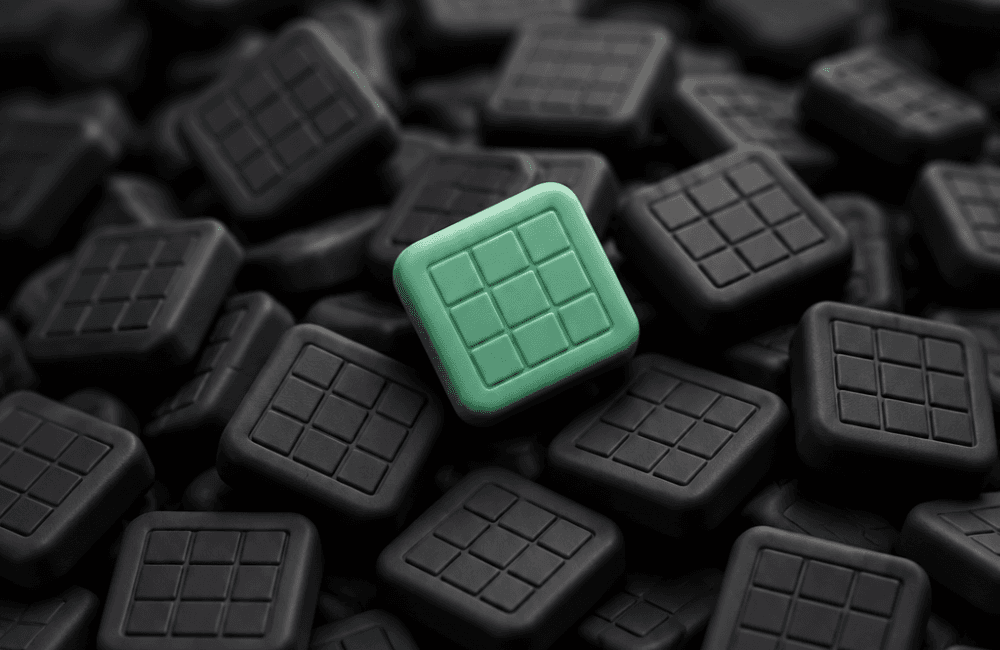 A pile of dark charcoal 3D tiles styled as small solar panels, with a single mint green panel resting slightly above the others near the top left of center, the image fading to black at the bottom.