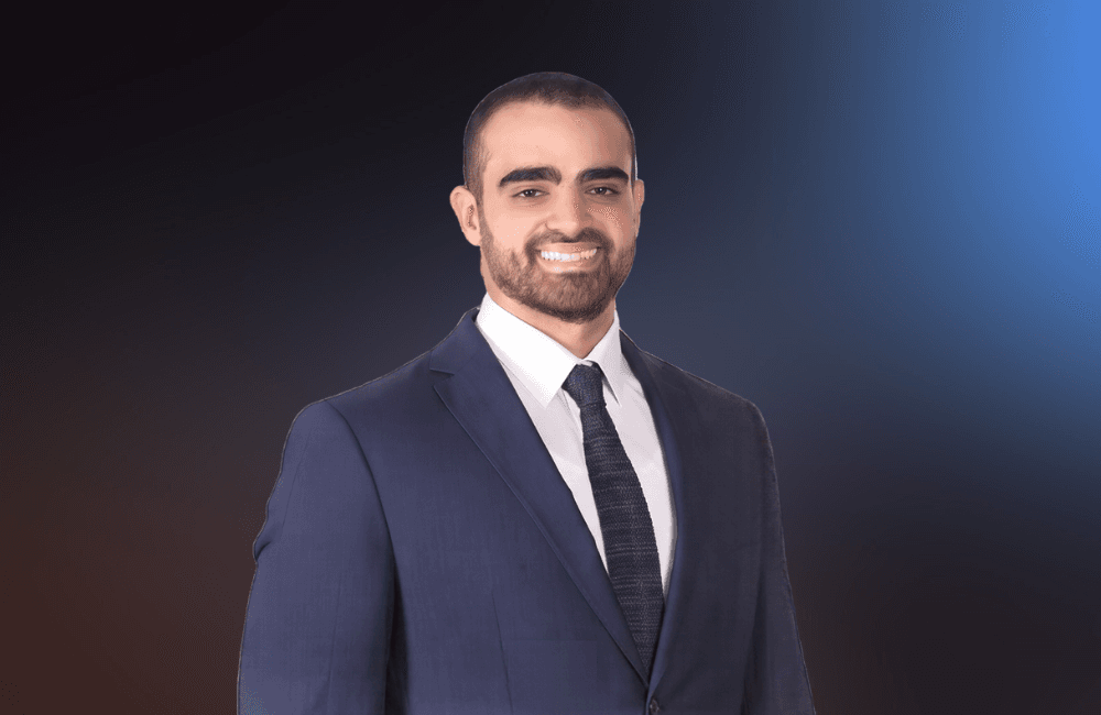 Fadi Kanaan in a navy suit standing in front of the American University of Beirut campus